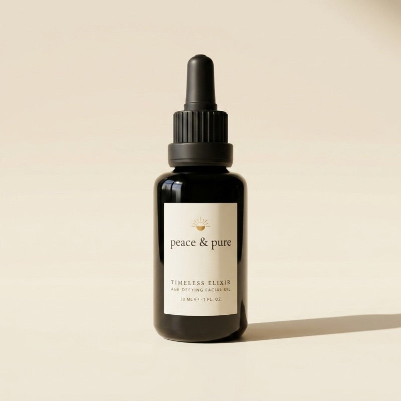 The Timeless Elixir bottle in black glass, lit softly against warm cream